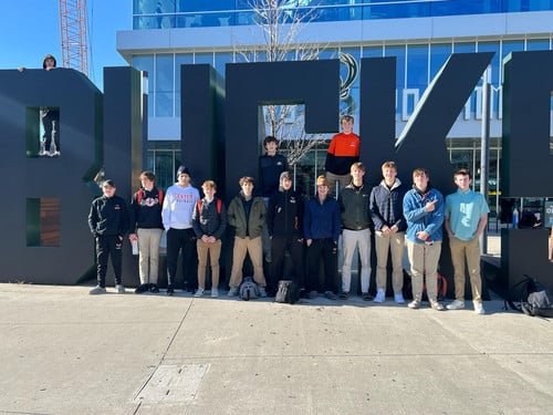 Boys Basketball in front of Bucks Sign